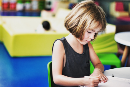 Decorative photo of child sitting at table