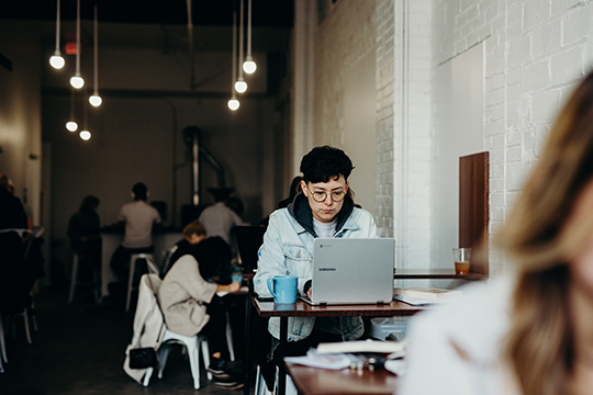 Decorative photo of person working on laptop