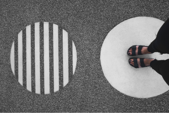 Decorative photo of feet on pavement
