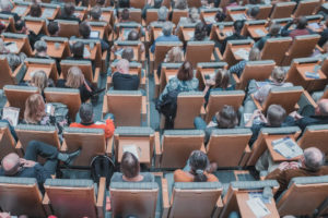 Decorative image of people in lecture hall