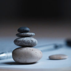 Decorative photo of rocks balanced on desk