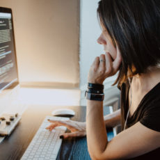 Photo of person at computer coding