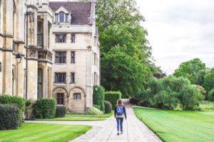 Decorative photo of person walking on campus