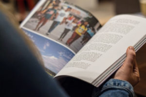 Decorative image of person reading publication