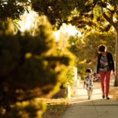 Decorative photo of person walking with child