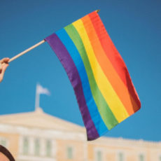Decorative image of person waving rainbow flag