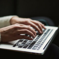 Decorative photo of person typing on laptop
