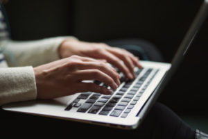 Decorative photo of person typing on laptop