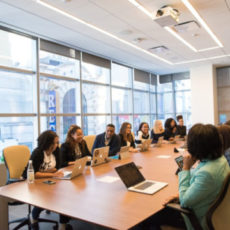 Decorative photo of people gathered around table