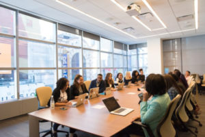 Decorative photo of people gathered around table