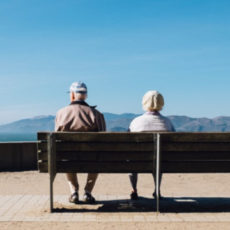 Photo of two people sitting on a bench