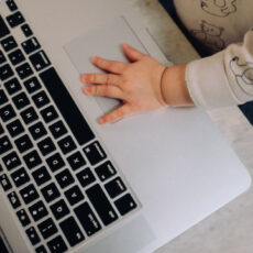 Decorative photo of baby's hand on laptop