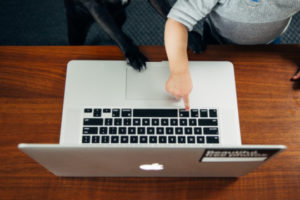 Decorative photo of baby pointing to laptop