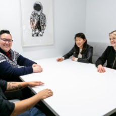 Decorative photo of group sitting around table