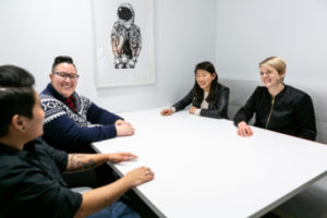 Decorative photo of group sitting around table