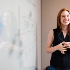 Decorative photo of person standing at whiteboard