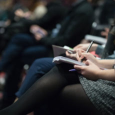 Decorative photo of people sitting in audience