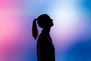Decorative photo of person's silhouette against multi-coloured background