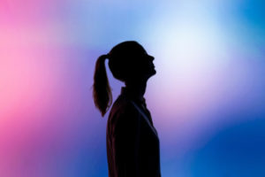 Decorative photo of person's silhouette against multi-coloured background 