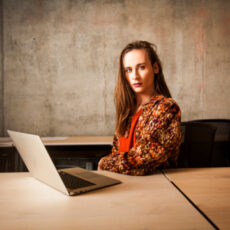 Photo of person sitting at laptop