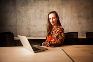 Decorative photo of person sitting at laptop