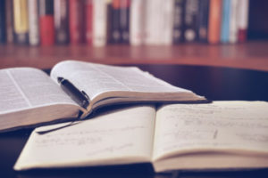 Photo of notebook, pen, and book