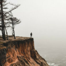 Decorative photo of person on edge of cliff