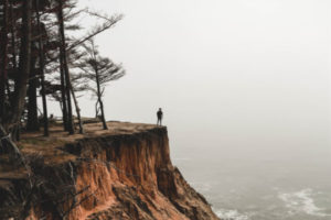 Decorative photo of person on edge of cliff