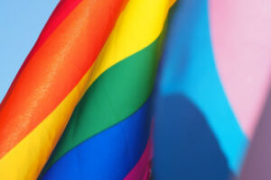 Decorative photo of rainbow flag and trans pride flag