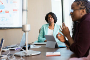 Decorative photo of two people in a meeting