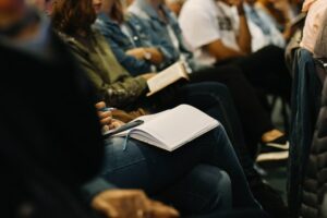 Decorate photo of people taking notes in audience