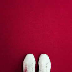 Decorative photo of white shoes against red background