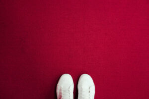 Decorative photo of white shoes against red background