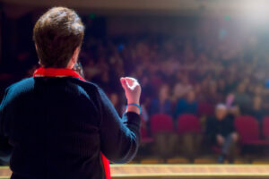 Decorative photo of person giving speech