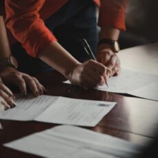 decorative photo of people signing documents