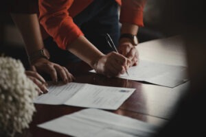 decorative photo of people signing documents