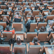 Decorative Photo of People attending conference