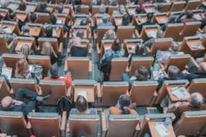 Decorative Photo of People attending conference