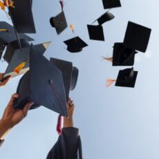 Black hat of the graduates floating in the sky