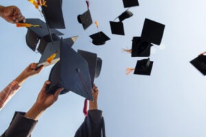 Black hat of the graduates floating in the sky