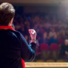 Decorative image of person giving a speech