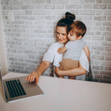 Decorative photo of parent working with child in their arms