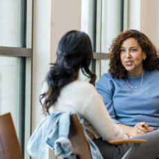 Decorative photo of two people talking