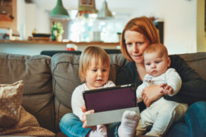 Decorative picture of person with two children and tablet in their lab