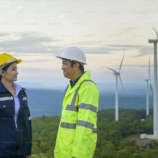 Decorative photo of people in front of wind mills