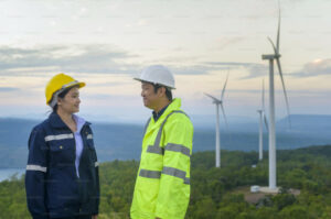 Decorative photo of people in front of wind mills