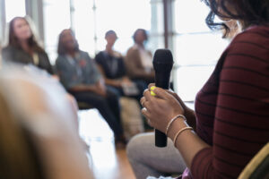 close up photo of person holding a microphone