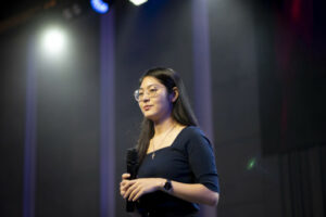 Person standing on stage with mircophone