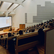 Decorative photo of people in auditorium