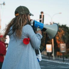 Decorative photo of protester holding microphone